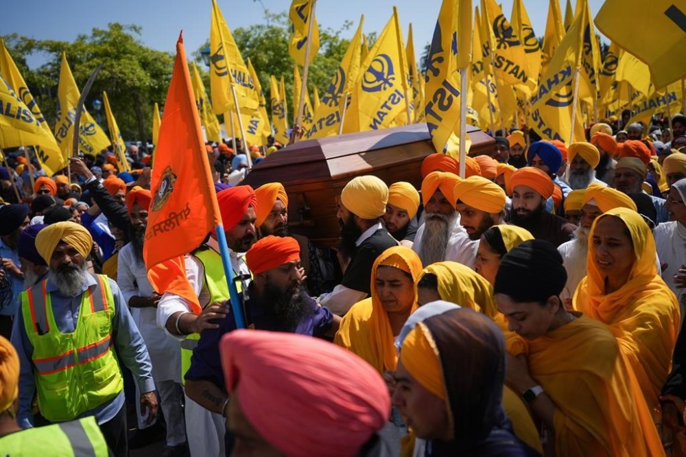 Mourners carry the casket of Sikh community leader and temple president Hardeep Singh Nijjar during part of of a day-long funeral service for him in Surrey, B.C., Sunday, June 25, 2023. Nijjar was gunned down in his vehicle while leaving the Guru Nanak Sikh Gurdwara parking lot June 18. THE CANADIAN PRESS/Darryl Dyck
