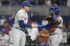 New York Mets relief pitcher Adam Ottavino, left, shakes hands with catcher Omar Narvaez, right, after defeating the Miami Marlins in a baseball game, Monday, Sept. 18, 2023, in Miami. (AP Photo/Lynne Sladky)