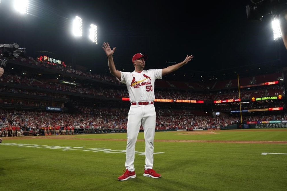 ;St. Louis Cardinals starting pitcher Adam Wainwright celebrates after earning the win in a baseball game against the Milwaukee Brewers for his 200th career victory Monday, Sept. 18, 2023, in St. Louis. (AP Photo/Jeff Roberson)