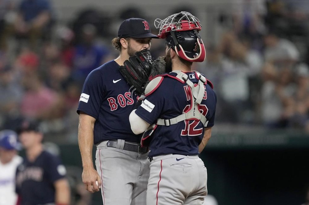 Boston Red Sox starting pitcher Kutter Crawford, left, and catcher Connor Wong, right, talk during a mound visit in the sixth inning of a baseball game against the Texas Rangers in Arlington, Texas, Monday, Sept. 18, 2023. (AP Photo/Tony Gutierrez)