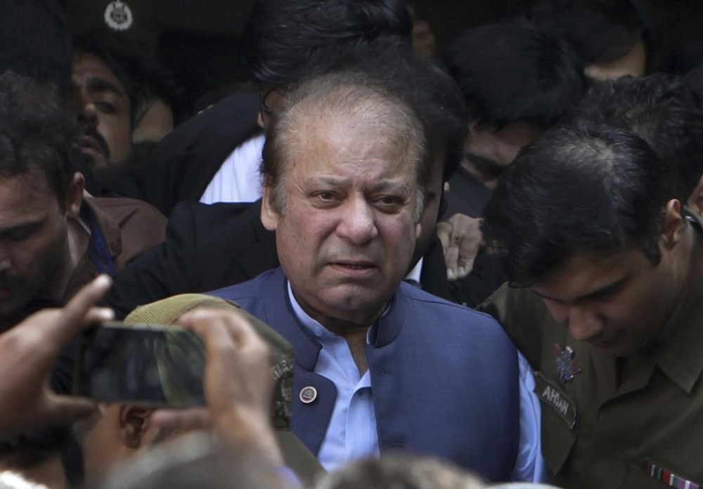 FILE - Former Pakistani Prime Minister Nawaz Sharif leaves a court in Lahore, Pakistan, on Oct. 8, 2018. Sharif is claiming that the country’s former powerful military and spy chiefs orchestrated his ouster in 2017, when he was forced to step down after being convicted of corruption. Sharif spoke on Monday, Sept. 18, 2023, to leaders of his Pakistan Muslim League party via a video link from London, where he has been living in self-imposed exile since 2019. (AP Photo/K.M. Chaudary, File)