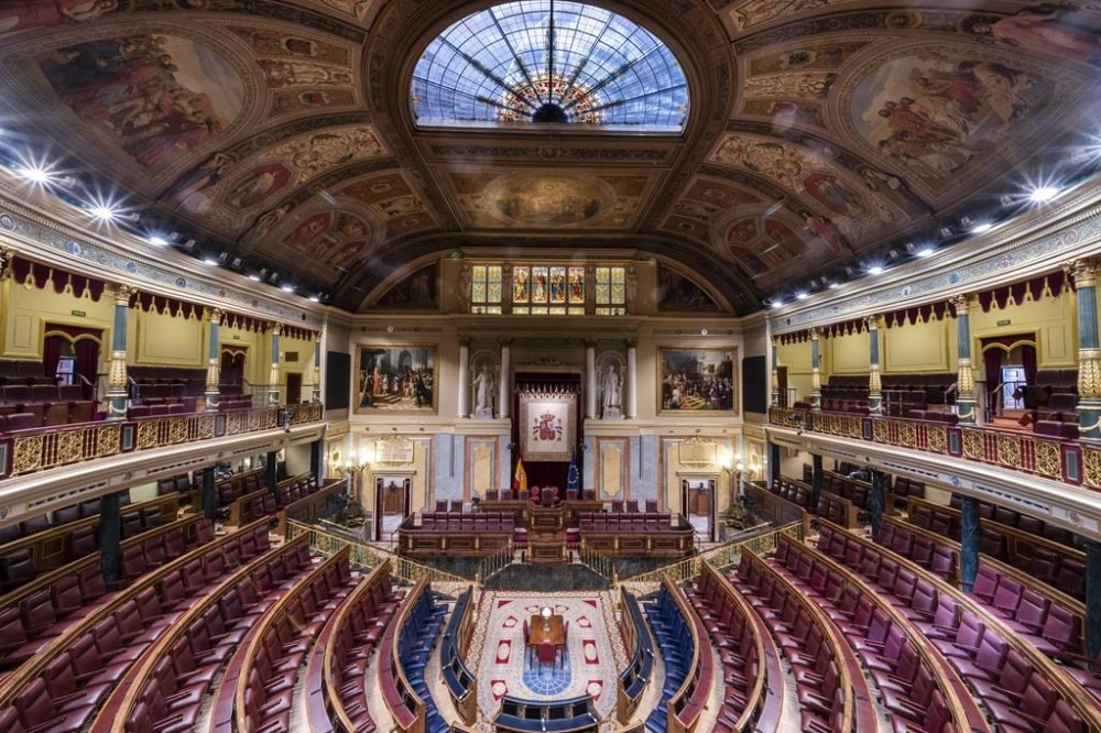 FILE - Empty seats of Spanish parliament's lower house in Madrid, Spain, on June 14, 2023. Spain’s Parliament is set to allow its national legislators to use the country’s minority languages of Catalan, Basque and Galician in the national Parliament for the first time on Tuesday, Sept. 19, 2023. (AP Photo/Bernat Armangue, File)