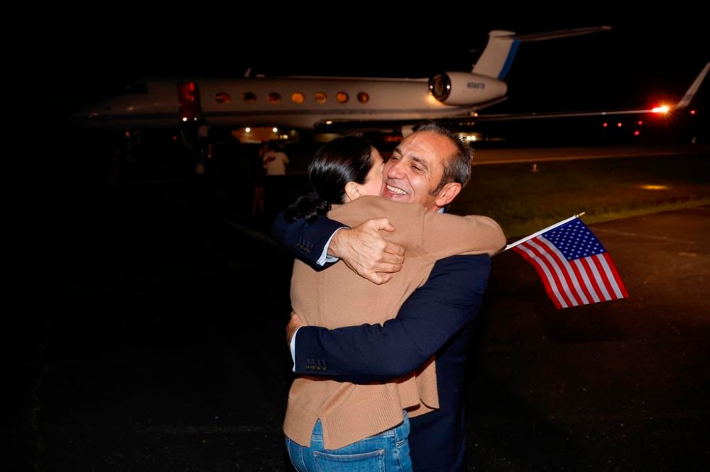Family members embrace freed American Emad Shargi after he and four fellow detainees were released in a prisoner swap deal between U.S and Iran, as he arrives at Davison Army Airfield, Tuesday, Sept. 19, 2023 at Fort Belvoir, Va. (Jonathan Ernst/Pool via AP)