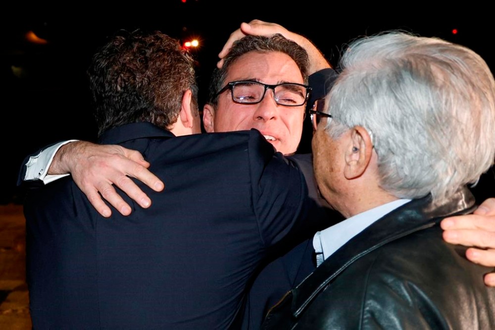 Family members embrace freed American Siamak Namazi after he and four fellow detainees were released in a prisoner swap deal and arrive at Davison Army Airfield, Tuesday, Sept. 19, 2003 at Fort Belvoir, Va. (Jonathan Ernst/Pool via AP)