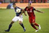 Toronto FC's Victor Vazquez battles for the ball with New England Revolution's Brandon Bye during the second half of MLS soccer action in Toronto, Saturday September 29, 2018. Vazquez is looking forward to a reunion Wednesday with Lionel Messi in Florida, having . risen through the ranks with Messi at FC Barcelona's famed youth academy. THE CANADIAN PRESS/Mark Blinch