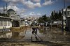 FILE - A man cleans a street on the aftermath of floods caused by heavy rains in Istanbul, Turkey, Sept. 6, 2023. Before crossing the Mediterranean, the devastating storm that dumped torrential rains along the Libyan coast raged for days and caused extensive damage in central Greece and parts of Bulgaria and Turkey, a region where such extreme storms are up to 10 times more likely and up to 40% more intense because of climate change, scientists said. (AP Photo/Khalil Hamra, File)