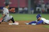 Kansas City Royals' Kyle Isbel, right, beats the tag by Cleveland Guardians shortstop Gabriel Arias after hitting a double during the third inning of a baseball game Tuesday, Sept. 19, 2023, in Kansas City, Mo. (AP Photo/Charlie Riedel)