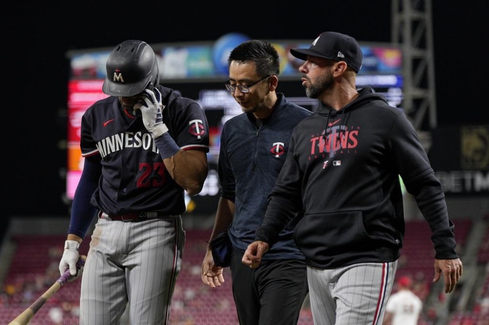 Minnesota Twins' Royce Lewis (23) walks to the dugout after being injured during his at-bat in the eighth inning of the team's baseball game against the Cincinnati Reds in Cincinnati, Tuesday, Sept. 19, 2023. (AP Photo/Jeff Dean)