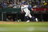 Texas Rangers' Robbie Grossman runs to second base while trying to advance on a fly out by Jonah Heim against the Boston Red Sox during the fourth inning of a baseball game, Tuesday, Sept. 19, 2023, in Arlington, Texas. (AP Photo/Julio Cortez)