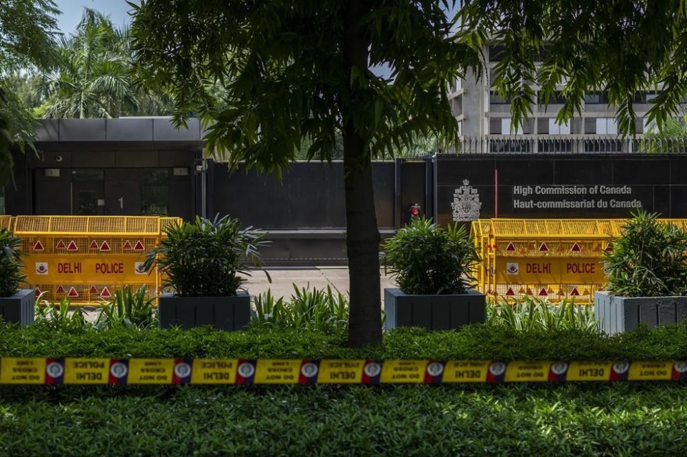 A police barricade tape is placed around the Canadian High Commission in New Delhi, India, Tuesday, Sept. 19, 2023. Tensions between India and Canada are high after Prime Minister Justin Trudeau's government expelled a top Indian diplomat and accused India of having links to the assassination in Canada of Sikh leader Hardeep Singh Nijjar, a strong supporter of an independent Sikh homeland. (AP Photo/Altaf Qadri)