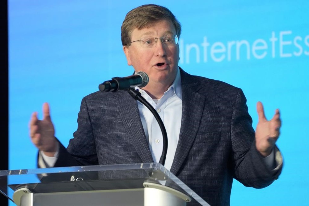 FILE - Republican Gov. Tate Reeves speaks at Bolton-Edwards Elementary/Middle School, in Bolton, Miss., on Tuesday, Aug. 22, 2023. On Wednesday, Sept. 20, 2023, Republican former U.S. Rep. Mike Parker, who was the 1999 GOP nominee for governor, announced he is endorsing Democratic gubernatorial nominee Brandon Presley over Reeves in the Nov. 7, 2023, general election. (AP Photo/Rogelio V. Solis, File)