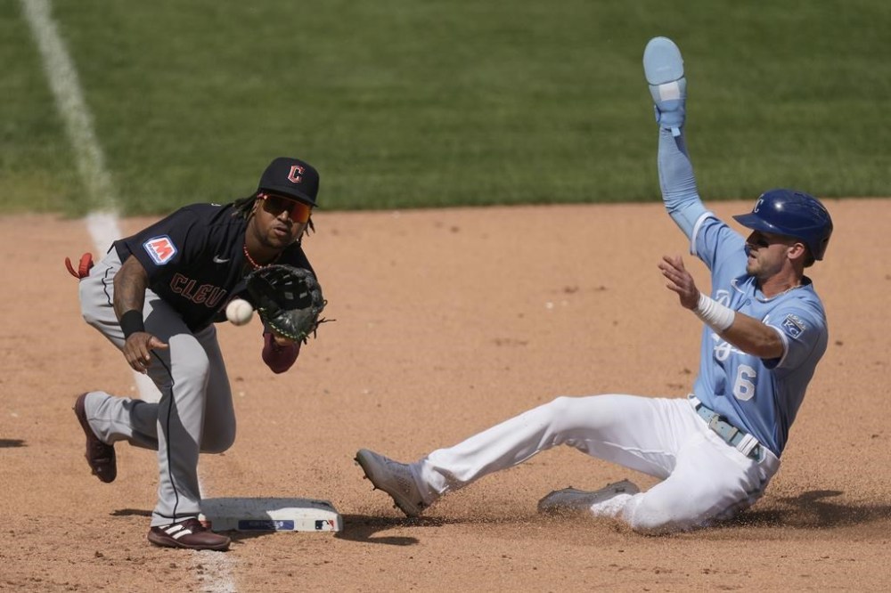 Kansas City Royals' Drew Waters (6) beats the tag by Cleveland Guardians third baseman Jose Ramirez to advance on a wild pitch during the fourth inning of a baseball game Wednesday, Sept. 20, 2023, in Kansas City, Mo. (AP Photo/Charlie Riedel)