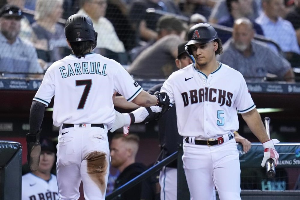 Arizona Diamondbacks' Corbin Carroll (7) celebrates his run scored against the San Francisco Giants with Diamondbacks' Alek Thomas (5) during the third inning of a baseball game Wednesday, Sept. 20, 2023, in Phoenix. (AP Photo/Ross D. Franklin)