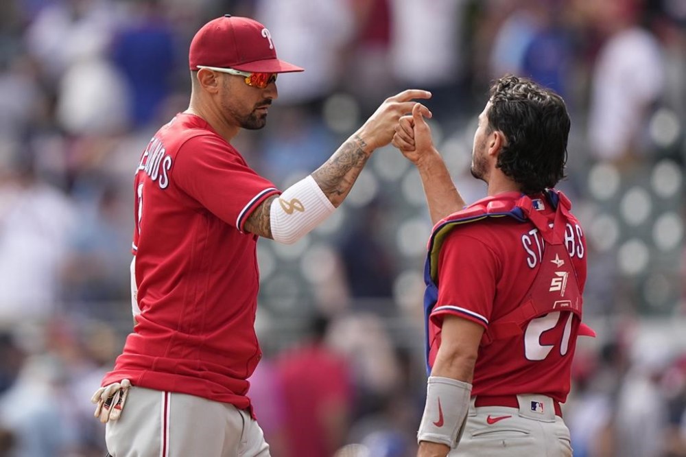 Philadelphia Phillies right fielder Nick Castellanos, left, celebrates with Philadelphia Phillies catcher Garrett Stubbs (21) after a win against the Atlanta Braves, Wednesday, Sept. 20, 2023, in Atlanta. (AP Photo/Brynn Anderson)