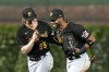 Pittsburgh Pirates right fielder Joshua Palacios, right, and center fielder Jack Suwinski celebrate the team's 13-7 win over the Chicago Cubs in a baseball game Wednesday, Sept. 20, 2023, in Chicago. (AP Photo/Charles Rex Arbogast)