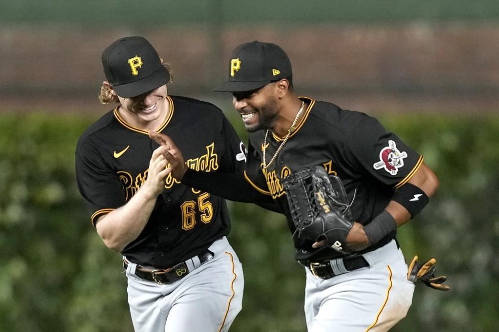Pittsburgh Pirates right fielder Joshua Palacios, right, and center fielder Jack Suwinski celebrate the team's 13-7 win over the Chicago Cubs in a baseball game Wednesday, Sept. 20, 2023, in Chicago. (AP Photo/Charles Rex Arbogast)