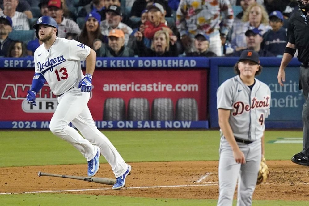 Los Angeles Dodgers' Max Muncy, left, heads to first for a solo home run as Detroit Tigers starting pitcher Reese Olson watches during the sixth inning of a baseball game Wednesday, Sept. 20, 2023, in Los Angeles. (AP Photo/Mark J. Terrill)
