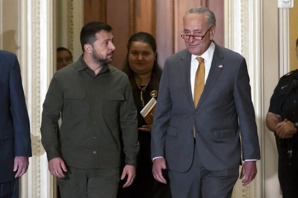 Ukrainian President Volodymyr Zelenskyy, left, walks with Senate Majority Leader Chuck Schumer of N.Y., right, at Capitol Hill on Thursday, Sept. 21, 2023, in Washington. (AP Photo/Mark Schiefelbein)