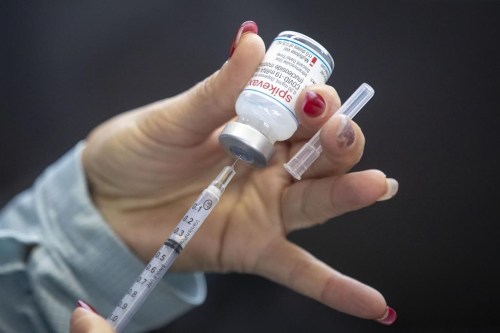 Public health officials are recommending people get the updated COVID-19 vaccine if it's been more than six months since their last shot or infection. A person draws out Moderna vaccine at St. Lawrence College in Kingston, Ont., on Sunday Jan. 2, 2022.THE CANADIAN PRESS/Lars Hagberg