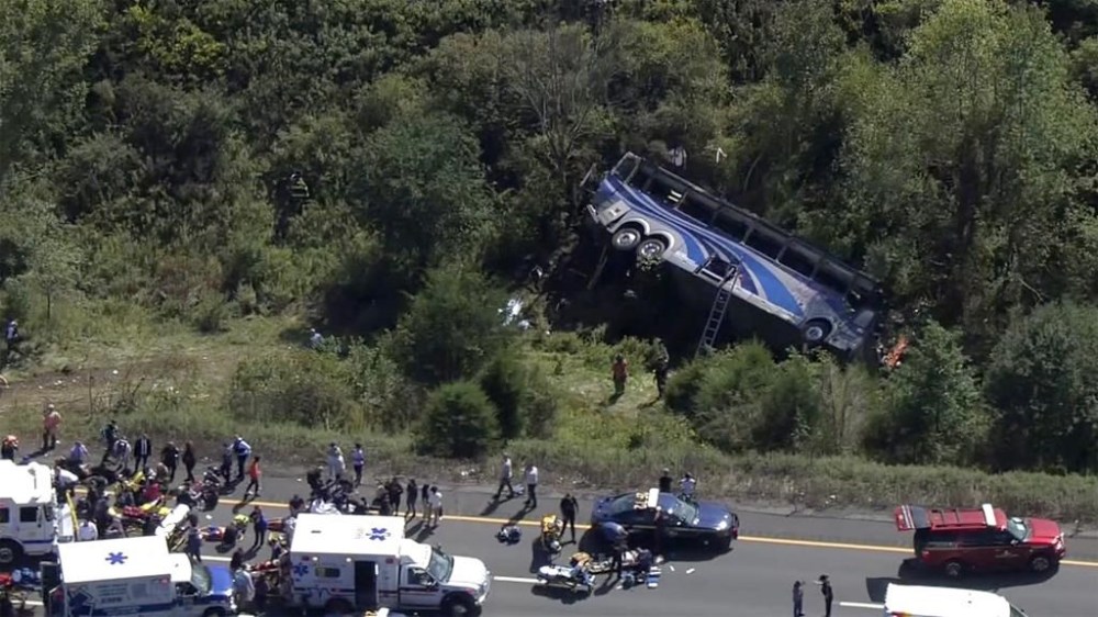 Emergency responders work the scene of a bus crash, in Wawayanda, N.Y., Thursday, Sept. 21, 2023. The charter bus carrying high school students to a band camp hurtled off a New York highway and down an embankment, killing one person and hurting dozens of others, officials said. (NBC New York via AP)