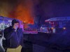 FILE - In this handout file photo released by the Governor of Sevastopol Mikhail Razvozhaev telegram channel on Wednesday, Sept. 13, 2023, Razvozhaev speaks on the mobile phone as smoke and flame rise from a burning Sevastopol Shipyard in Crimea. On Friday, Sept. 22, 2023, Ukraine carried out a fiery missile strike on the main headquarters of Russia’s Black Sea Fleet, a Russian official said. (Sevastopol Governor Mikhail Razvozhaev telegram channel via AP, File)