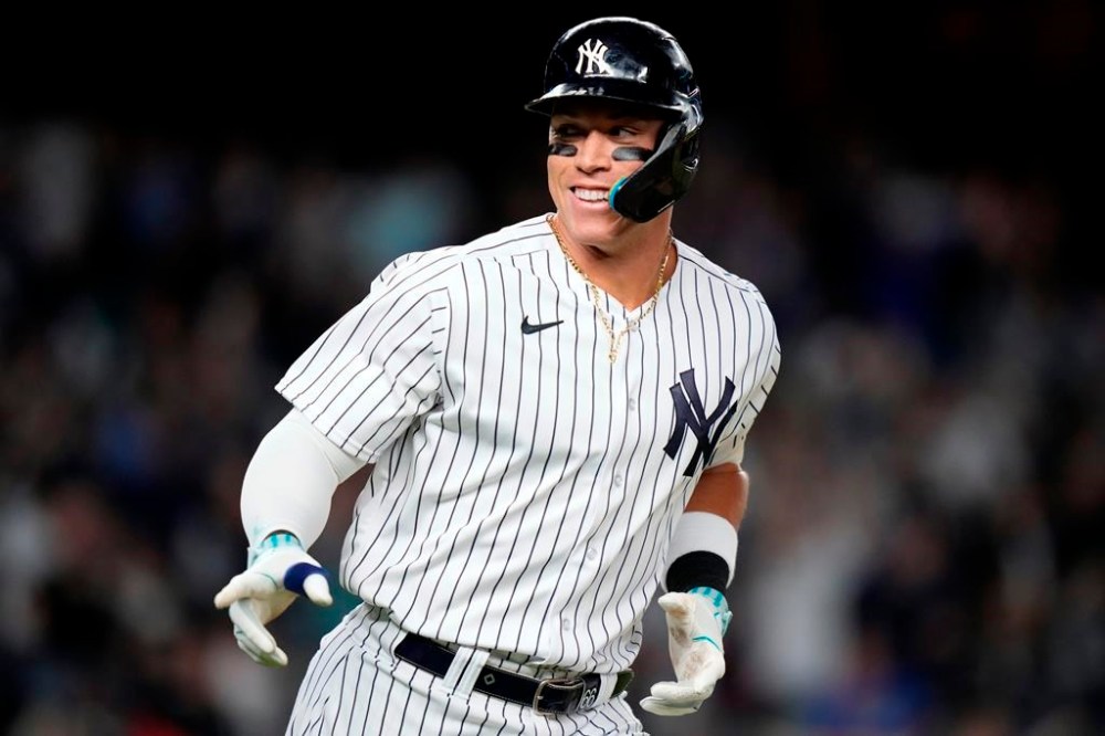 New York Yankees' Aaron Judge gestures to teammates after hitting a home run against the Arizona Diamondbacks during the seventh inning of a baseball game Friday, Sept. 22, 2023, in New York. (AP Photo/Frank Franklin II)