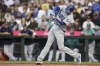 Los Angeles Dodgers' Freddie Freeman hits a single during the first inning of a baseball game against the Seattle Mariners, Saturday, Sept. 16, 2023, in Seattle. (AP Photo/Maddy Grassy)