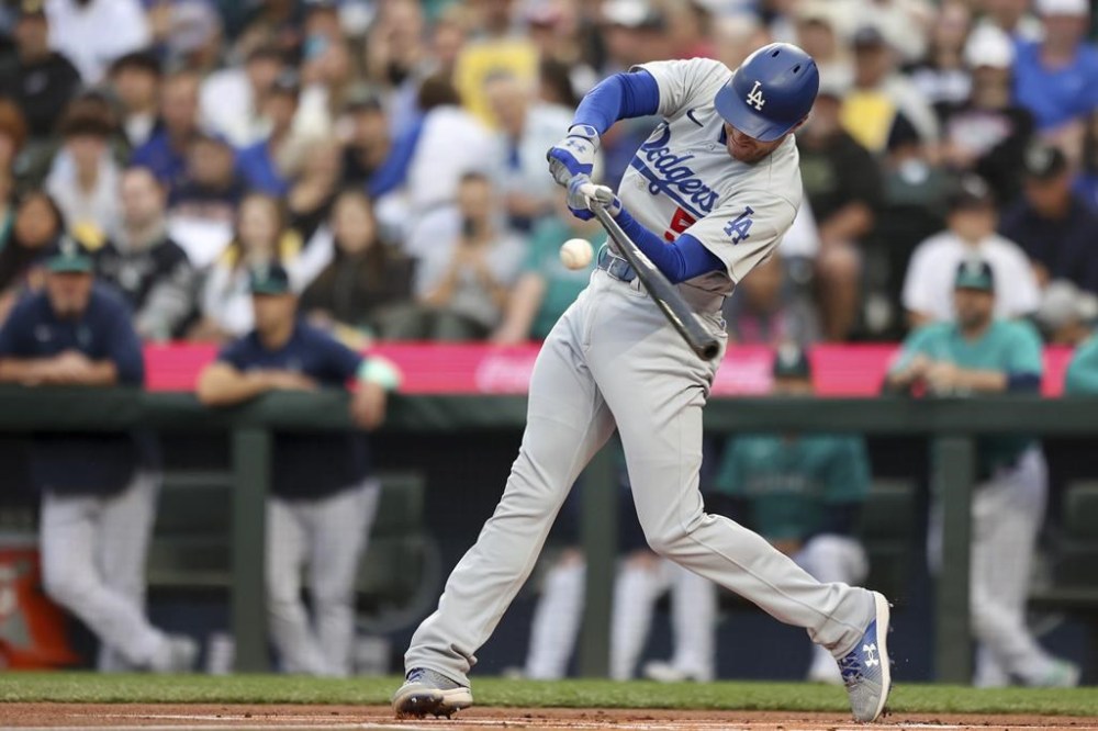 Los Angeles Dodgers' Freddie Freeman hits a single during the first inning of a baseball game against the Seattle Mariners, Saturday, Sept. 16, 2023, in Seattle. (AP Photo/Maddy Grassy)