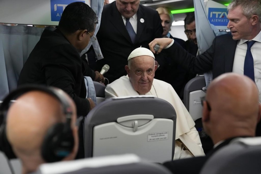Pope Francis arrives for a press conference on board an airplane on his flight back from Marseille to Rome, Saturday, Sept. 23, 2023. Francis just ended a two-day visit to Marseille where he joined Catholic bishops from the Mediterranean region on discussions largely focused on migration. (AP Photo/Alessandra Tarantino, Pool)