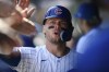 Chicago Cubs' Nico Hoerner celebrates in the dugout with teammates after scoring on an Ian Happ double during the first inning of a baseball game against the Colorado Rockies, Saturday, Sept. 23, 2023, in Chicago. (AP Photo/Paul Beaty)