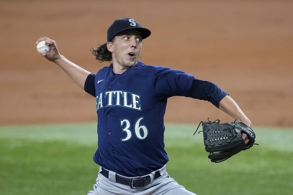 Seattle Mariners starting pitcher Logan Gilbert throws to the Texas Rangers in the second inning of a baseball game, Saturday, Sept. 23, 2023, in Arlington, Texas. (AP Photo/Tony Gutierrez)