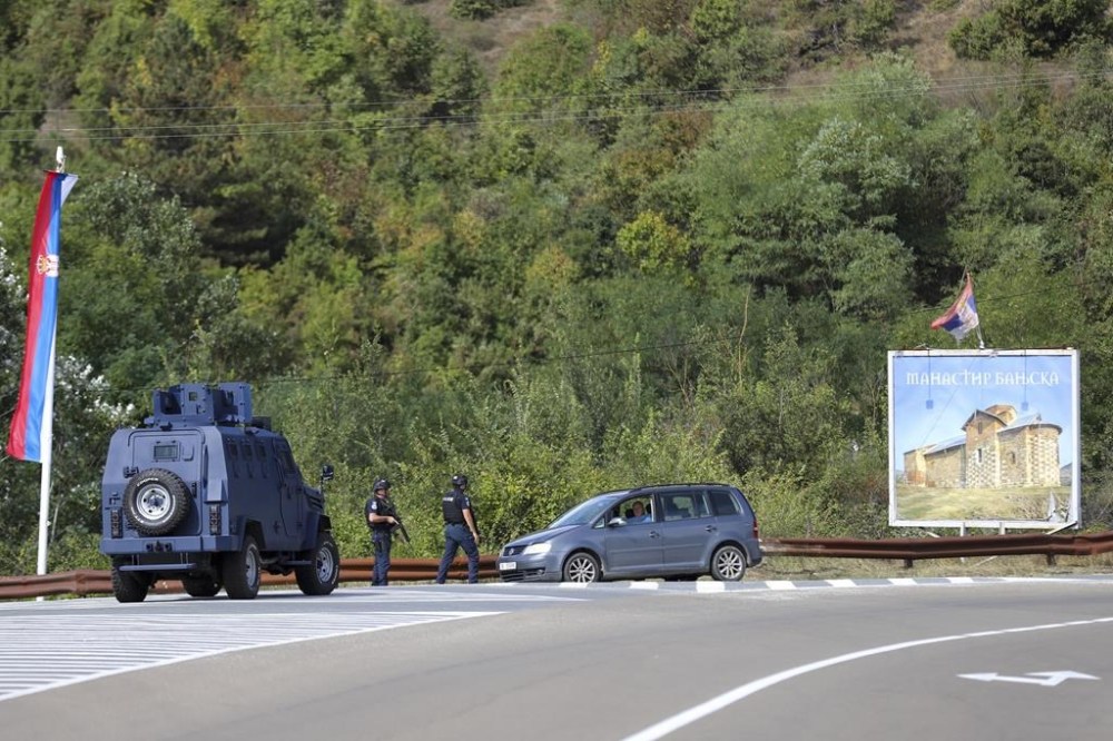Kosovo police officers guard the road near the village of Banjska, 55 kilometers (35 miles) north of the capital Pristina, northern Kosovo, Sunday, Sept. 24, 2023. Prime Minister Albin Kurti on Sunday said one police officer was killed and another wounded in an attack he blamed on support from neighboring Serbia, increasing tensions between the two former war foes at a delicate moment in their European Union-facilitated dialogue to normalize ties. (AP Photo/Bojan Slavkovic)