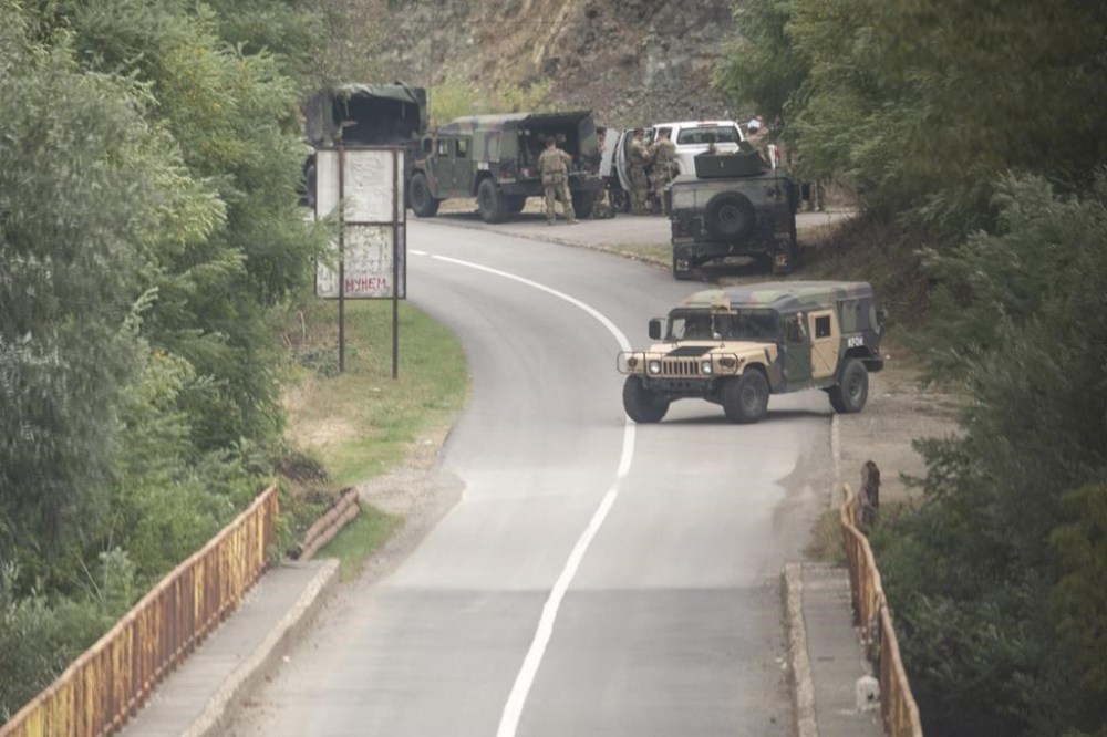 Members of NATO led peacekeeping mission in Kosovo set up checkpoint on the road leading to the Banjska Monastery in the village of Banjska on Sunday, Sept.24, 2023. Kosovo's prime minister on Sunday said one police officer was killed and another wounded in an attack he blamed on support from neighboring Serbia, increasing tensions between the two former war foes at a delicate moment in their European Union-facilitated dialogue to normalize ties. (AP Photo/Visar Kryeziu)