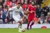 West Ham's Edson Alvarez, left, is challenged by Liverpool's Mohamed Salah during the English Premier League soccer match between Liverpool and West Ham at the Anfield stadium in Liverpool, England, Sunday, Sept. 24, 2023. (AP Photo/Jon Super)