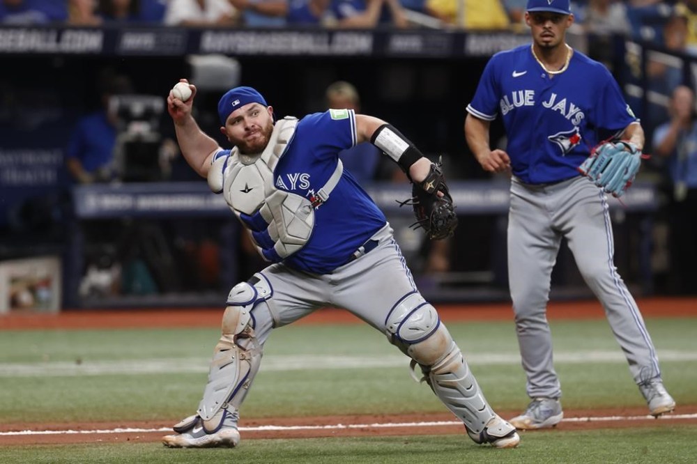 Toronto Blue Jays catcher Alejandro Kirk throws to first for the final out of the game against the Tampa Bay Rays during the ninth inning of a baseball game, Sunday, Sept. 24, 2023, in St. Petersburg, Fla. The Rays' Junior Caminero was out at first. (AP Photo/Scott Audette)