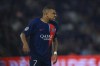 PSG's Kylian Mbappe grimaces after sustaining an injury during the French League One soccer match between Paris Saint Germain and Olympique de Marseille at Parc des Princes stadium in Paris, France, Sunday, Sept. 24, 2023. (AP Photo/Aurelien Morissard)