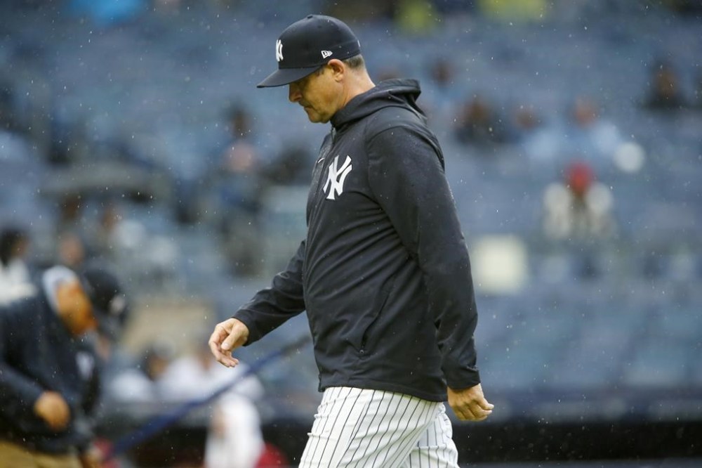 New York Yankees manager Aaron Boone walks back to the dugout after making a pitching change in the seventh inning during a baseball game against the Arizona Diamondbacks, Sunday, Sept. 24, 2023, in New York. (AP Photo/John Munson)