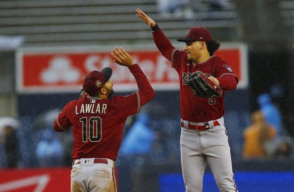 Arizona Diamondbacks shortstop Jordan Lawlar (10) and centerfielder Alek Thomas celebrate after defeating the New York Yankees during a baseball game, Sept. 24, 2023, in New York. (AP Photo/John Munson)