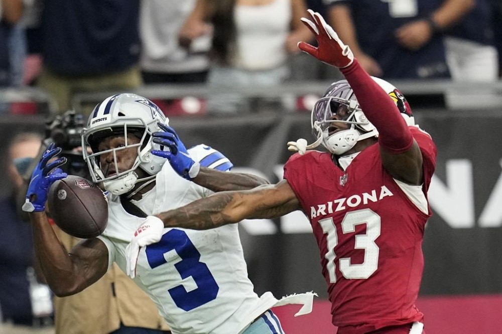 Dallas Cowboys wide receiver Brandin Cooks (3) misses the catch as Arizona Cardinals cornerback Kei'Trel Clark (13) during the first half of an NFL football game, Sunday, Sept. 24, 2023, in Glendale, Ariz. (AP Photo/Ross D. Franklin)
