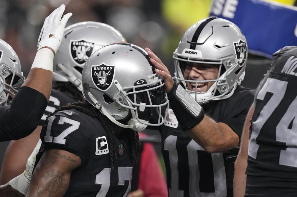 Las Vegas Raiders wide receiver Davante Adams (17) celebrates with quarterback Jimmy Garoppolo (10) after Adams' touchdown catch during the first half of an NFL football game against the Pittsburgh Steelers Sunday, Sept. 24, 2023, in Las Vegas. (AP Photo/Mark J. Terrill)