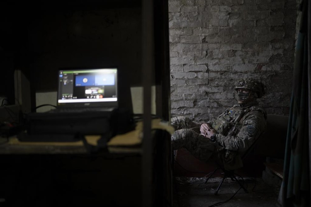 A Ukrainian member of an elite drone unit sits inside a basement in between operations on the front line in the outskirts of Kremmina, Ukraine, Sunday, Aug. 20, 2023. The drone unit's task is to destroy Russia's heavy machinery, armored vehicles and infantry. The drone unit's task is to destroy Russia's heavy machinery, armored vehicles and infantry. (AP Photo/Bram Janssen)