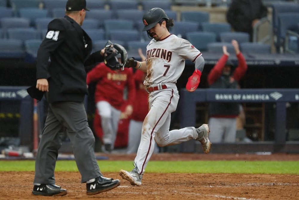 Arizona Diamondbacks' Corbin Carroll (7) scores a run against the New York Yankees during the seventh inning of a baseball game, Monday, Sept. 25, 2023, in New York. (AP Photo/Noah K. Murray)