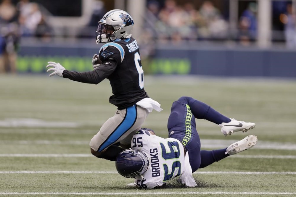 Carolina Panthers running back Miles Sanders is tackled by Seattle Seahawks linebacker Jordyn Brooks during the first half of an NFL football game Sunday, Sept. 24, 2023, in Seattle. (AP Photo/John Froschauer)