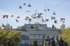 FILE - A flock of birds flies past as Moninder Singh, foreground right, a spokesperson for the British Columbia Gurdwaras Council (BCGC), waits to speak to reporters outside the Guru Nanak Sikh Gurdwara Sahib in Surrey, British Columbia, Canada, on Monday, Sept. 18, 2023, where temple president Hardeep Singh Nijjar was gunned down in his vehicle while leaving the temple parking lot in June. Canada expelled a top Indian diplomat Monday as it investigates what Prime Minister Justin Trudeau called credible allegations that India's government may have had links to the assassination in Canada of a Sikh activist. (Darryl Dyck/The Canadian Press via AP, File)