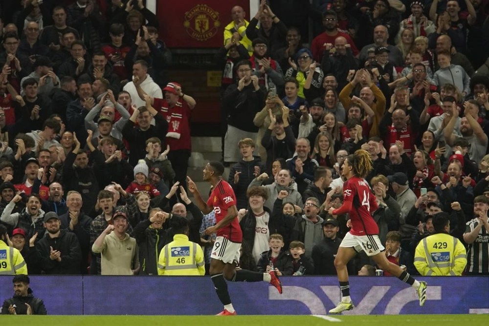 Manchester United's Anthony Martial, left, celebrates after scoring his side's third goal during the English League Cup third round soccer match between Manchester United and Crystal Palace at Old Trafford stadium in Manchester, England, Tuesday, Sept. 26, 2023. (AP Photo/Dave Thompson)
