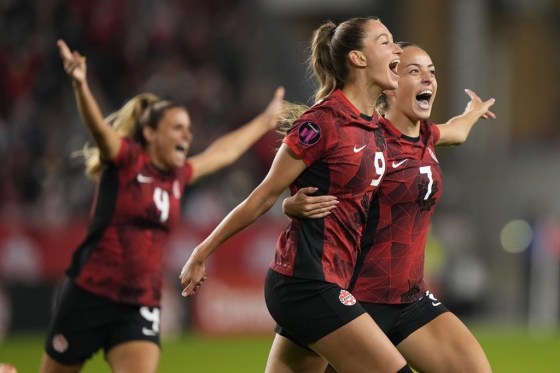 Canada's Jordyn Huitema, 9, celebrates her goal with teammates Julia Groos, 7, and Shelina Zadorshy, 4, against Jamaica in Toronto on Tuesday. (Nathan Denette / The Canadian Press)