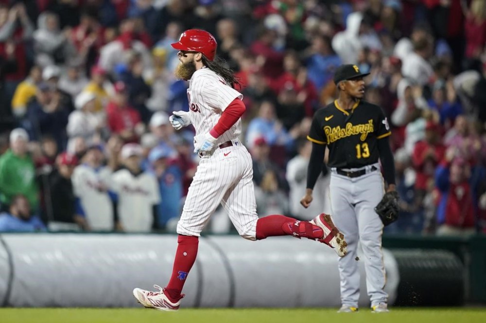 Philadelphia Phillies' Brandon Marsh, left, rounds the bases past Pittsburgh Pirates third baseman Ke'Bryan Hayes after hitting a home run during the sixth inning of a baseball game, Tuesday, Sept. 26, 2023, in Philadelphia. (AP Photo/Matt Slocum)