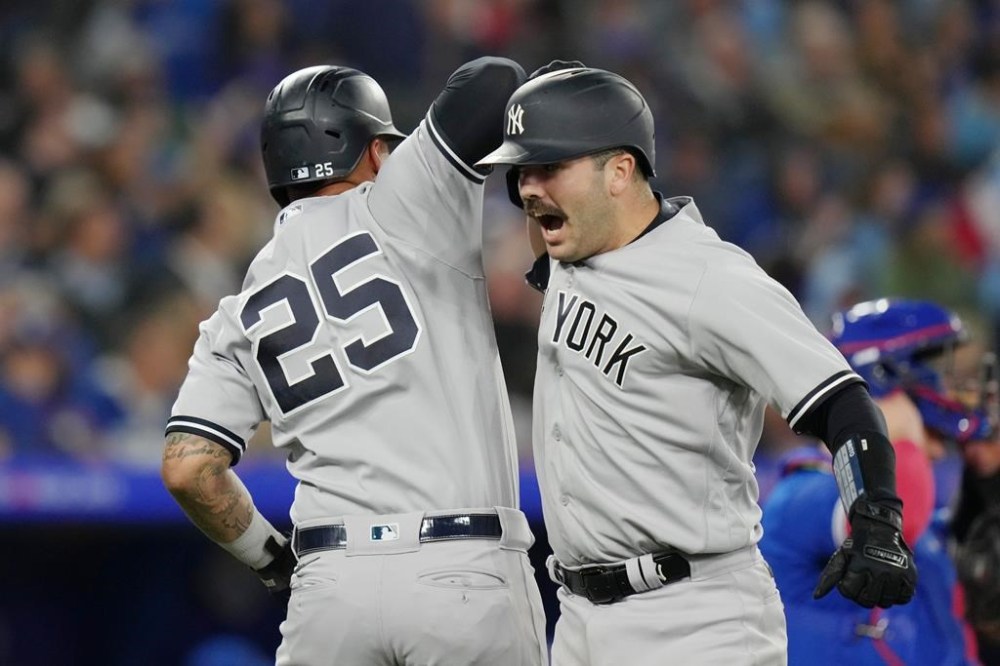 New York Yankees' Austin Wells (right) celebrates with teammate Gleyber Torres after hitting a two run home run off Toronto Blue Jays relief pitcher Jordan Romano during ninth inning American League MLB baseball action in Toronto on Tuesday, September 26, 2023. THE CANADIAN PRESS/Chris Young