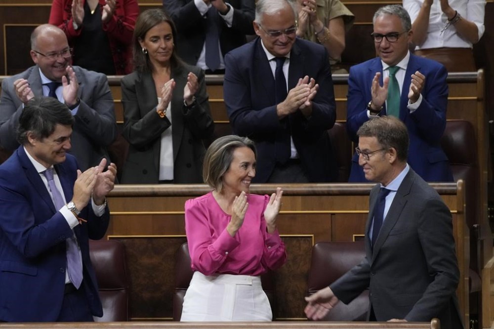 Alberto Nunez Feijoo, lower right, is applauded by party members after delivering a speech during an investiture session at the Spanish parliament in Madrid, Spain, Wednesday, Sept. 27, 2023. The leader of Spain's conservatives Alberto Feijoo faces the first of two investiture votes, Wednesday that will determine whether he can become prime minister. Spain's July 23 national election gave Feijoo's Popular Party the most seats in the parliament's 350-member lower chamber but well shy of an absolute majority. (AP Photo/Paul White)