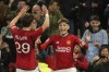 Manchester United's Alejandro Garnacho, right, celebrates after scoring his side's opening goal during the English League Cup third round soccer match between Manchester United and Crystal Palace at Old Trafford stadium in Manchester, England, Tuesday, Sept. 26, 2023. (AP Photo/Dave Thompson)